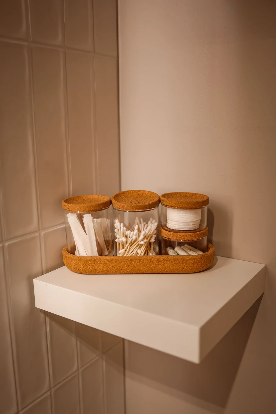 Toiletries on a bathroom corner shelf