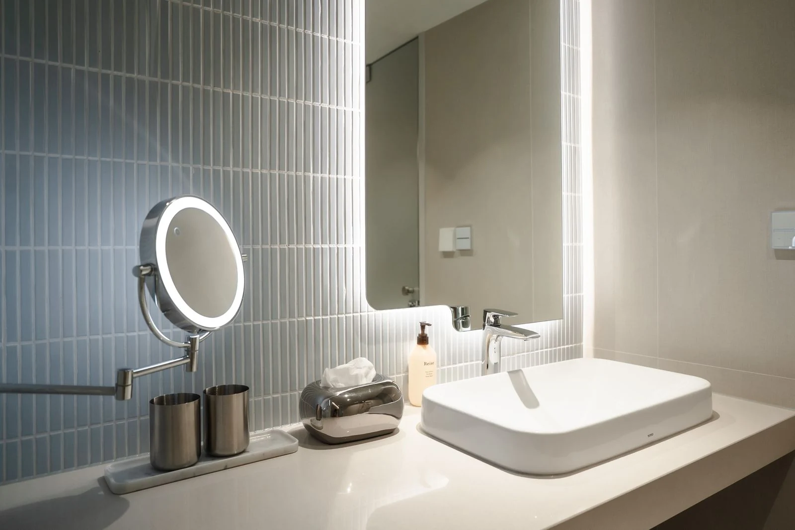 Bathroom basin and illuminated mirror