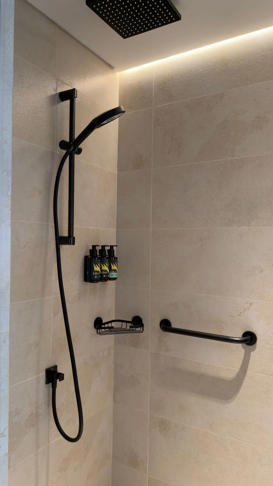 Walk-in shower with a black shower fitting