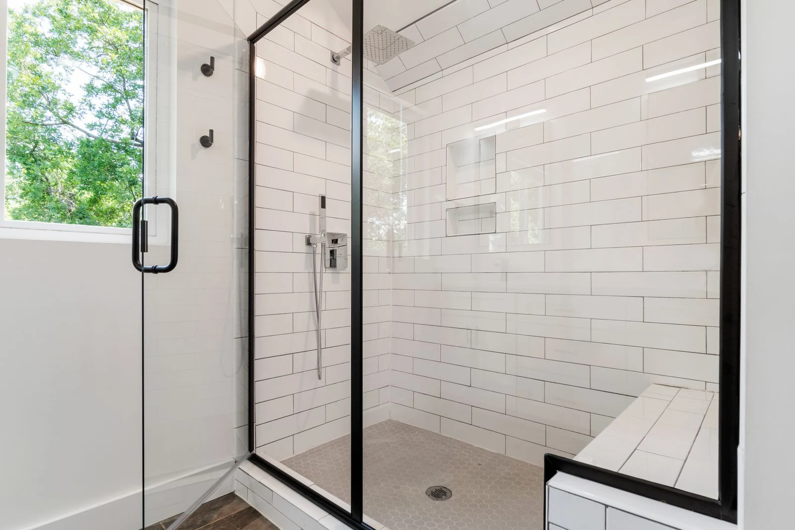 Glass shower screen and tiled walls