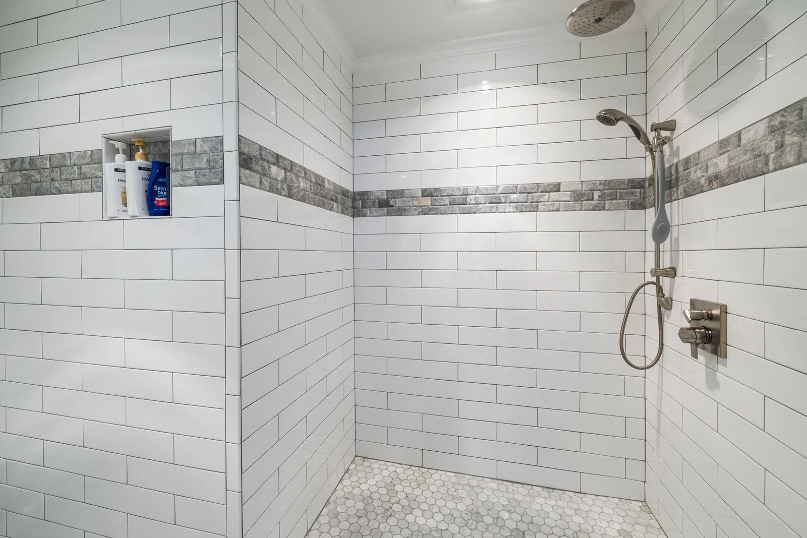 Shower fitting against white tiles